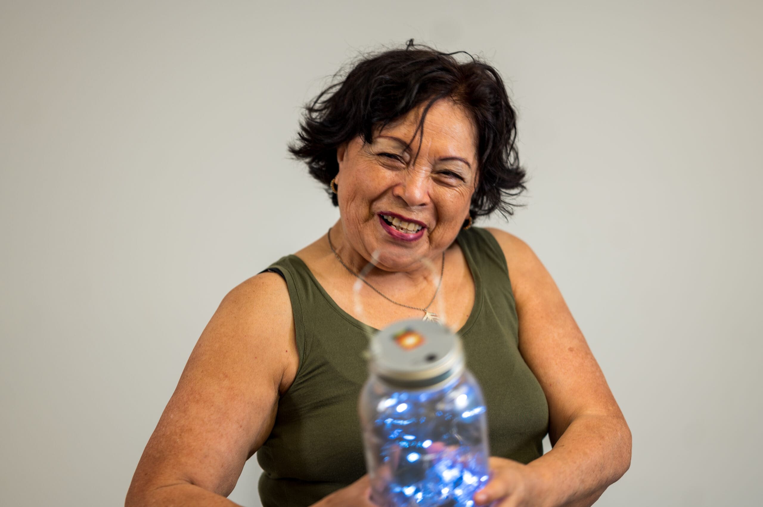 Woman hold jar filled with blue globes