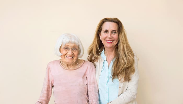 Portrait of smiling staff member and resident at Carlsbad by the Sea