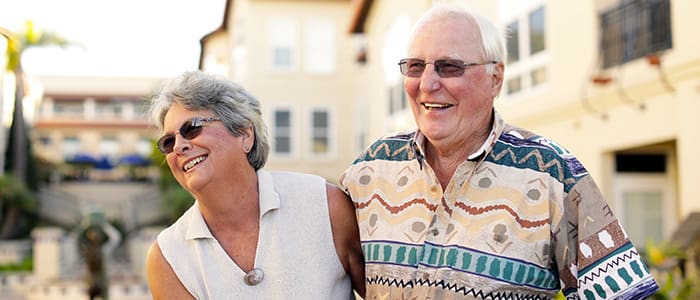 Portrait of a smiling couple outside Carlsbad by the Sea