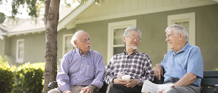 Image of smiling residents outside of Claremont Manor