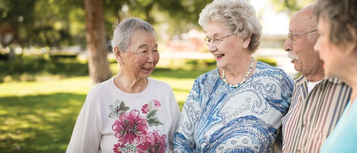 Portrait of a smiling group enjoying social activities around Claremont Manor