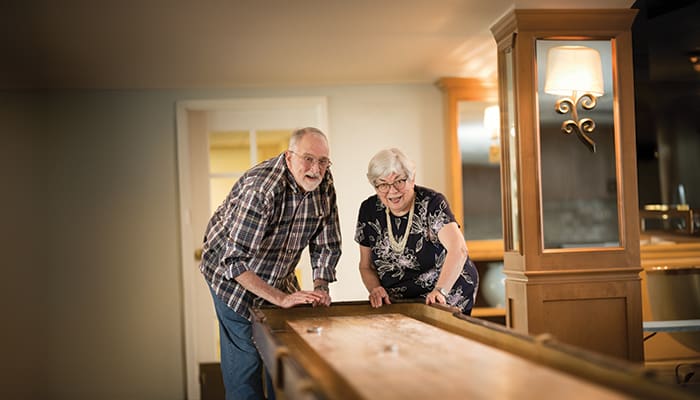 Portrait of a smiling couple enjoying one of the many amenities offered at Claremont Manor