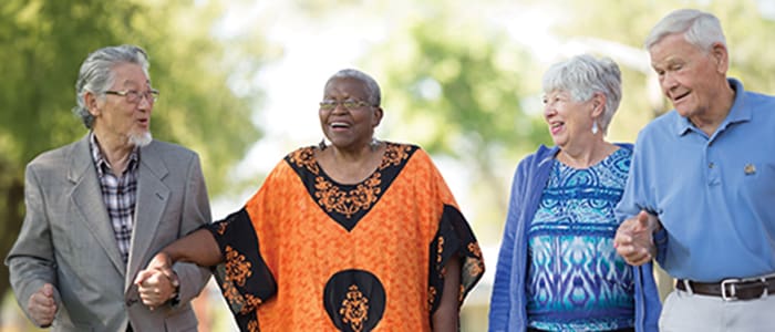 Portrait of a smiling group enjoying the Claremont Manor grounds