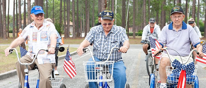 Photograph of smiling group outdoors on bicycles