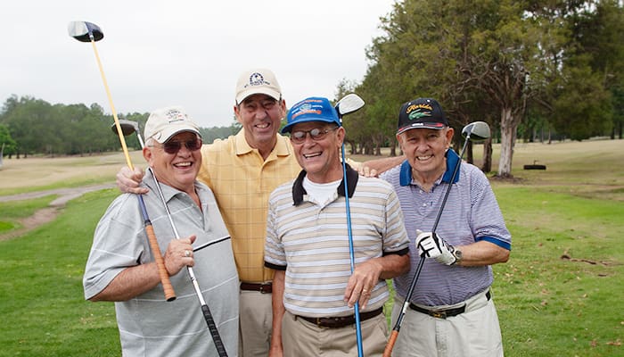 Group of smiling Cecil Pines residents during a social gathering