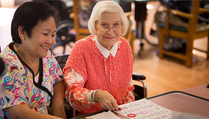 Portrait of smiling staff member and resident at Canterbury Woods