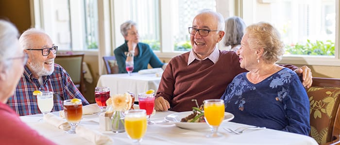 Portrait of smiling group in Canterbury Woods dining room