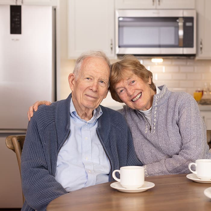 Portrait of a smiling couple in Canterbury Woods kitchen