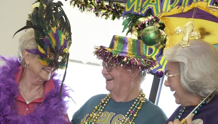 Group of smiling residents during an England Oaks social gathering