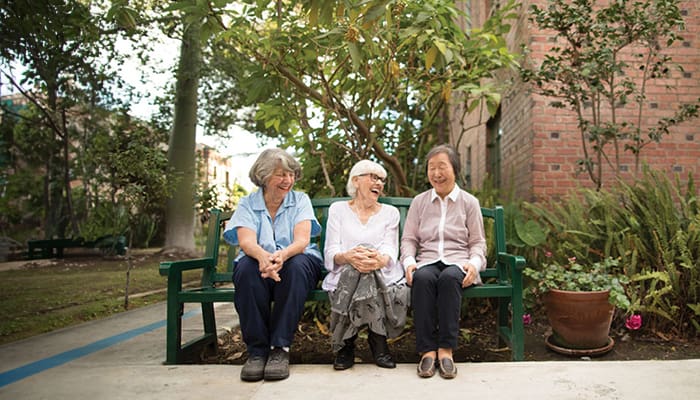 Portrait of a smiling group outside Kingsley Manor