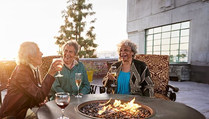 Portrait of a smiling group enjoying one of the many amenities offered at Kingsley Manor