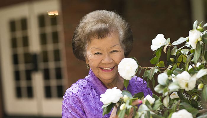 Portrait of a smiling woman outside a Kingsley Manor home