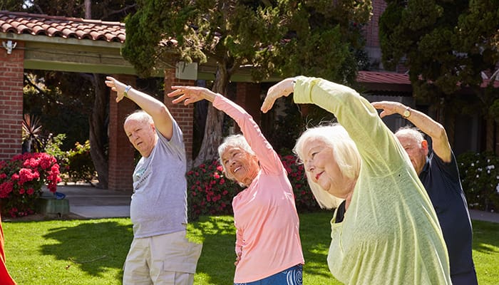 Portrait of a group exercising outside at Kingsley Manor