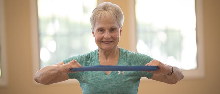 Resident participating in rehab at Vista Del Monte fitness center.