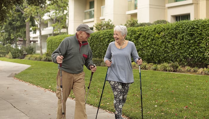 Portrait of residents enjoying a walk around the Villa Gardens community