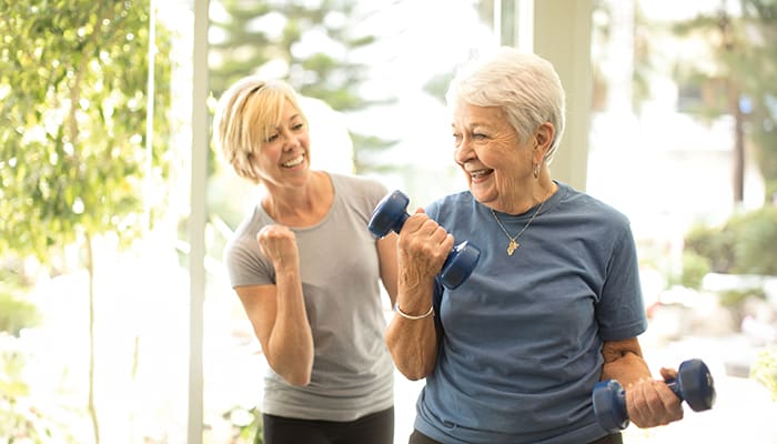 Portrait of smiling staff member and resident at Villa Gardens