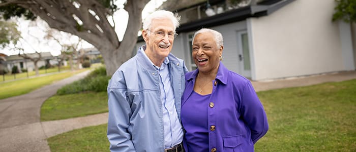 Portrat of man and woman smiling outside Wesley Palms