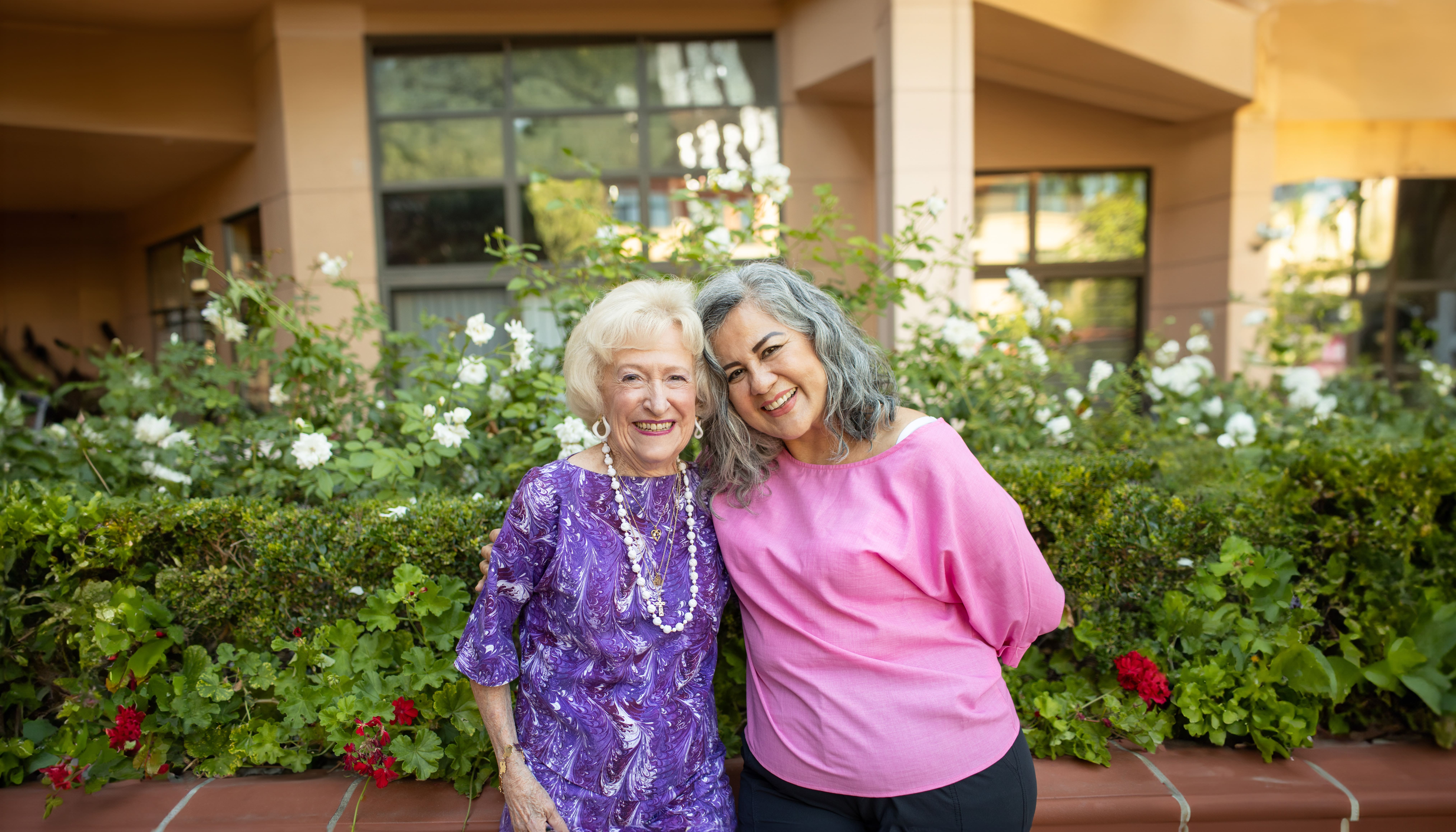 Portrait of smiling group outside Walnut Village