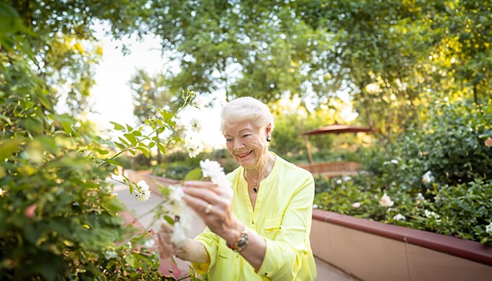 Resident tending plants in the Walnut Village Serenity Garden